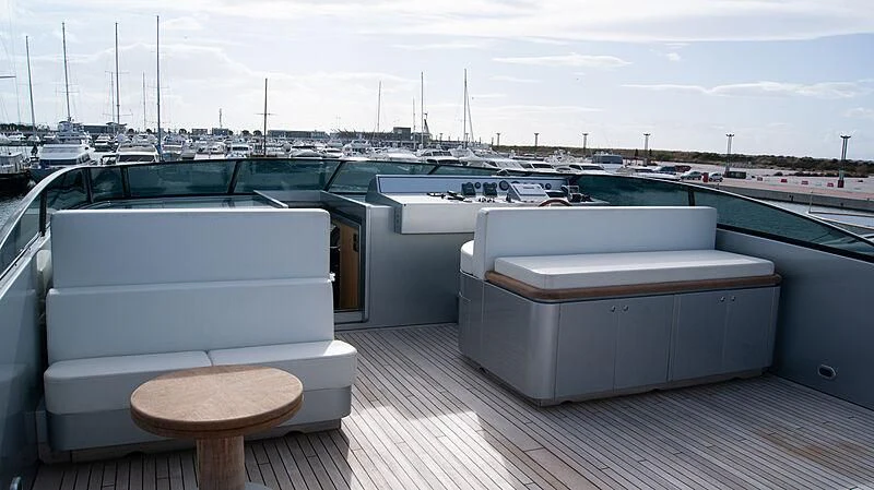 a deck with a table and stools on it aboard SOFIA Y Yacht for Sale