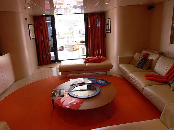 a living room with a table and couches aboard SOFIA Y Yacht for Sale