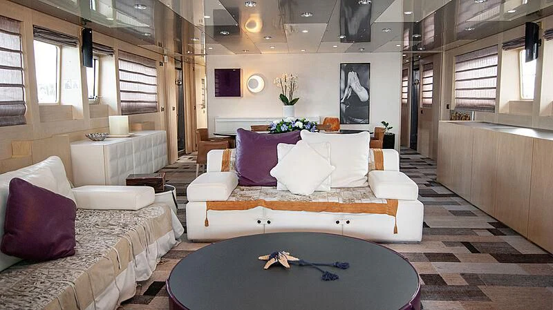 a room with a couch and a table with a blue rug aboard SOFIA Y Yacht for Sale
