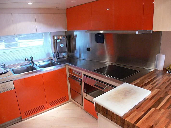 a kitchen with orange cabinets aboard SOFIA Y Yacht for Sale