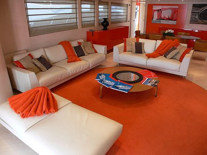 a living room with orange pillows aboard SOFIA Y Yacht for Sale