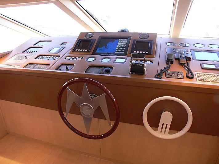 a wooden desk with a machine and a steering wheel aboard SOFIA Y Yacht for Sale