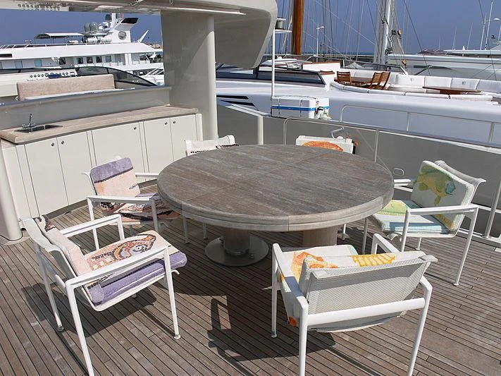 a table and chairs on a deck aboard SOFIA Y Yacht for Sale
