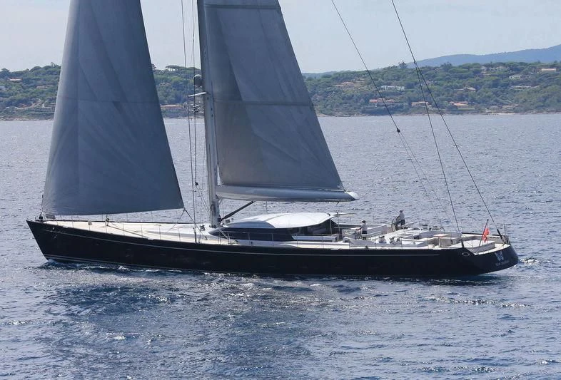 a black and white sailboat on the water aboard BLUE PAPILLON Yacht for Sale