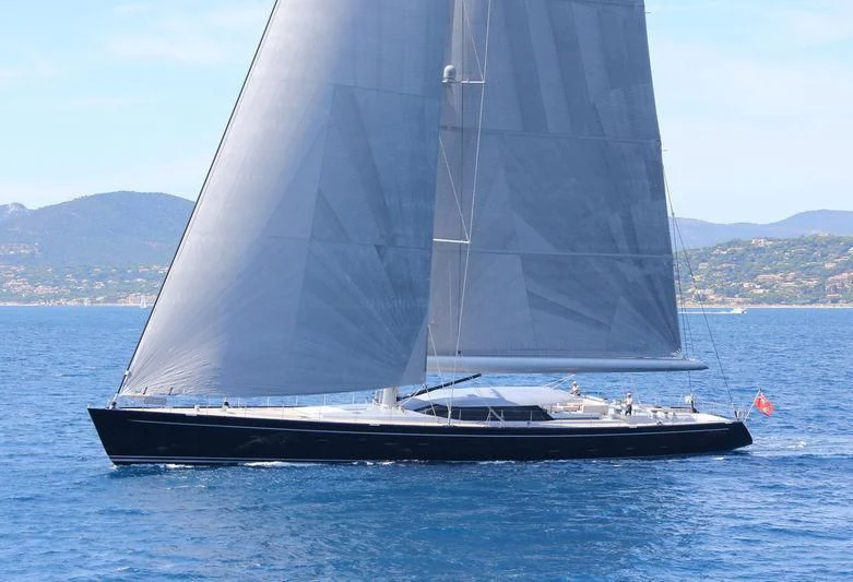 a black and white sailboat on the water aboard BLUE PAPILLON Yacht for Sale