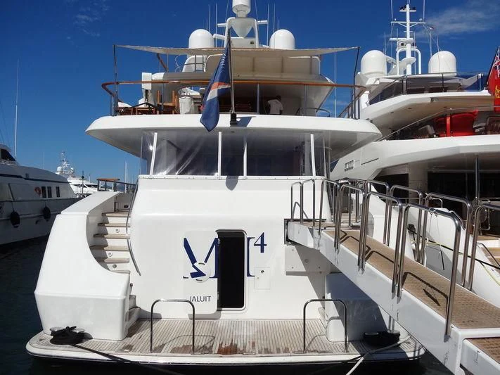 a large white boat with a blue stripe on the front aboard PACKAGE DEAL Yacht for Charter