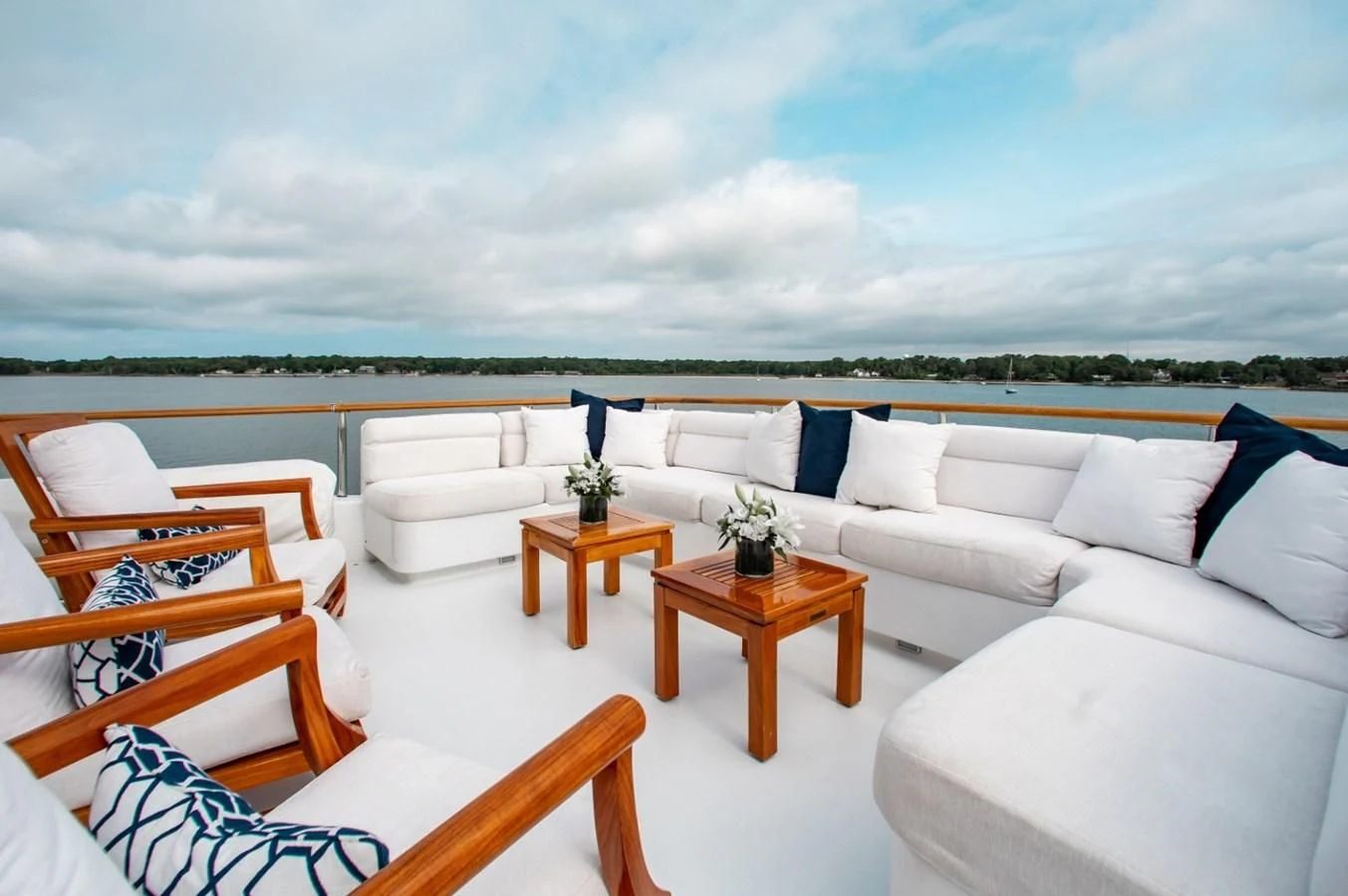 a living room with white couches and a table aboard PACKAGE DEAL Yacht for Charter