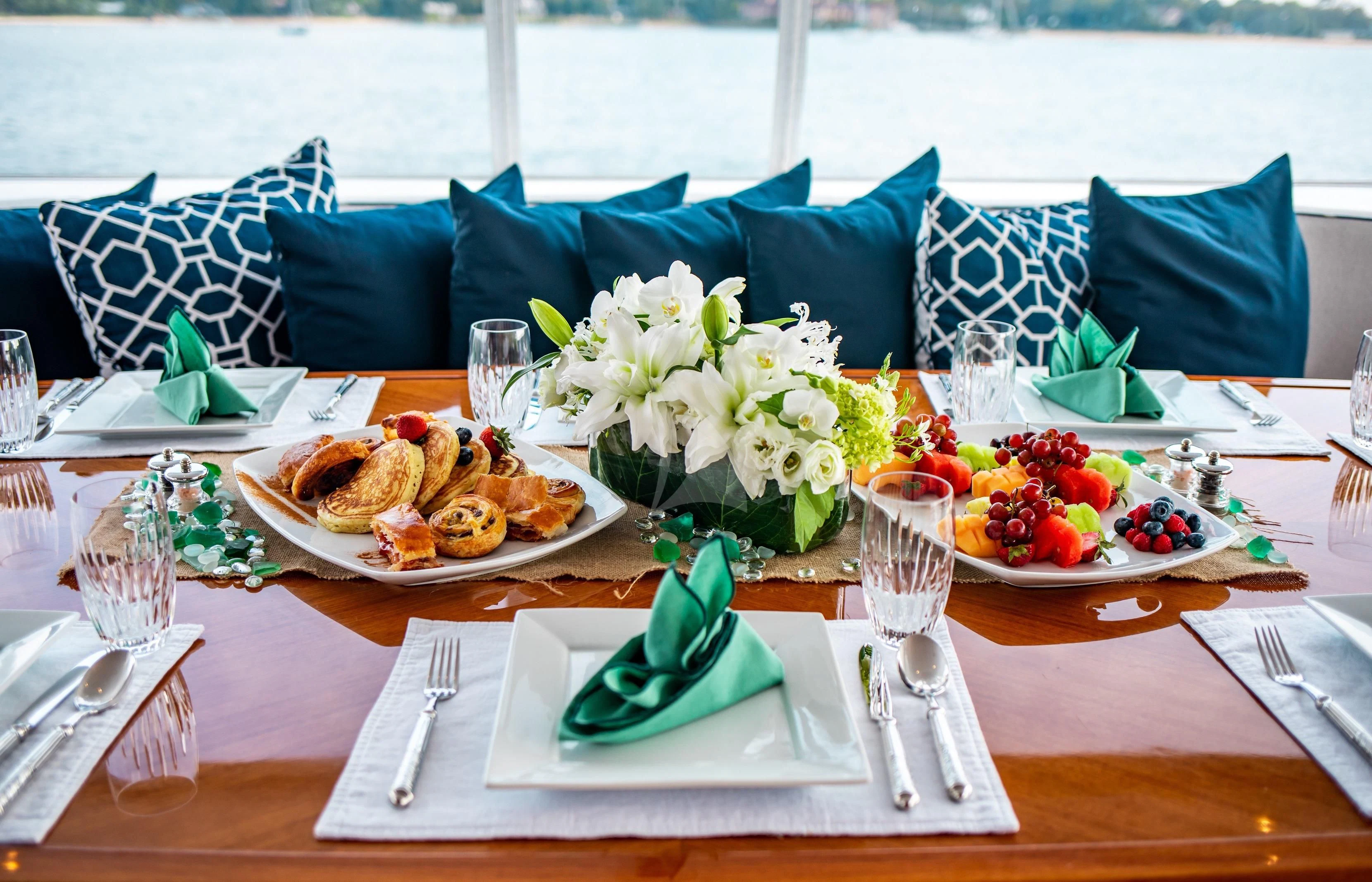 a table with food and plates aboard PACKAGE DEAL Yacht for Charter