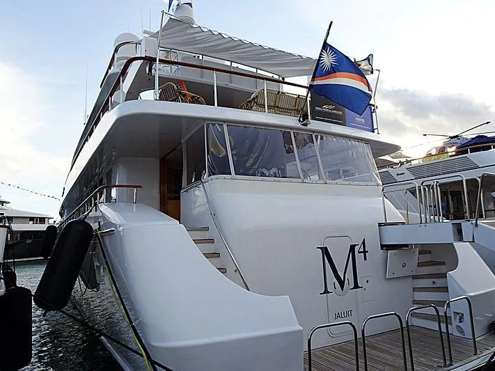 a boat with a flag on the front aboard PACKAGE DEAL Yacht for Charter