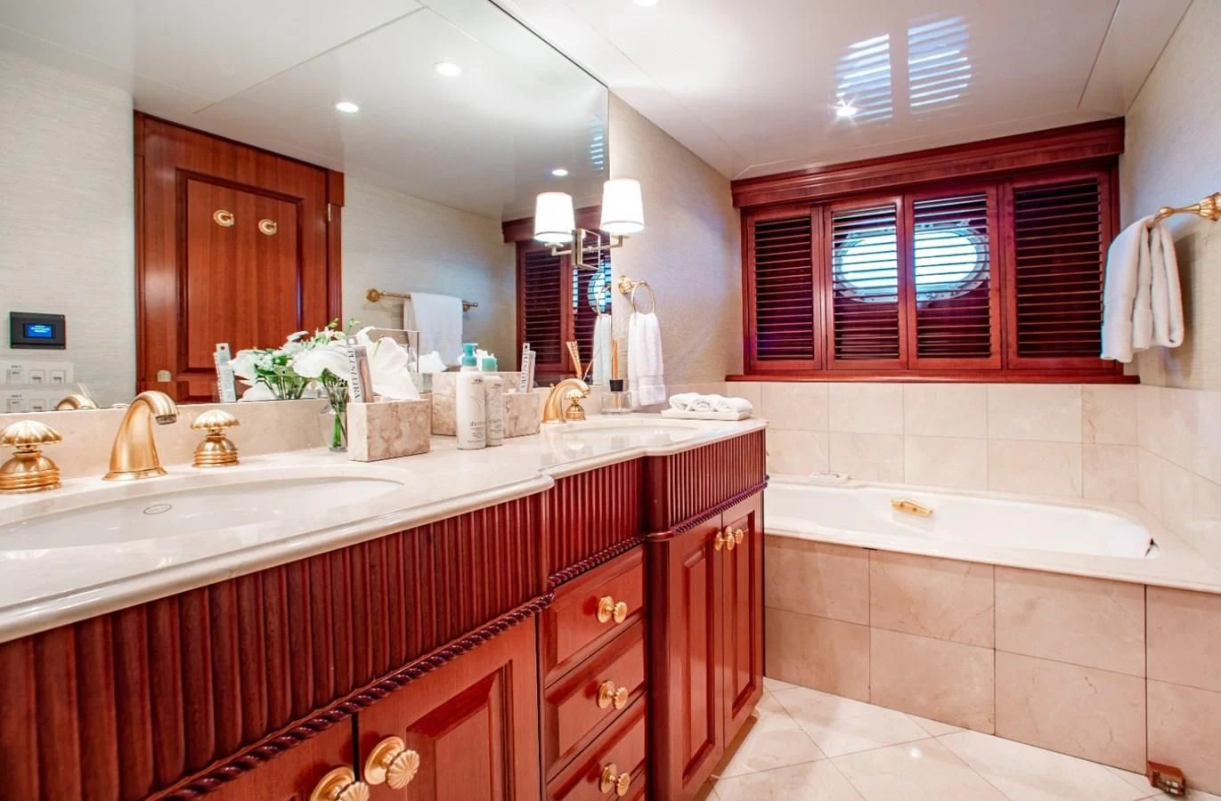 a bathroom with a tub sink and cabinets aboard PACKAGE DEAL Yacht for Charter
