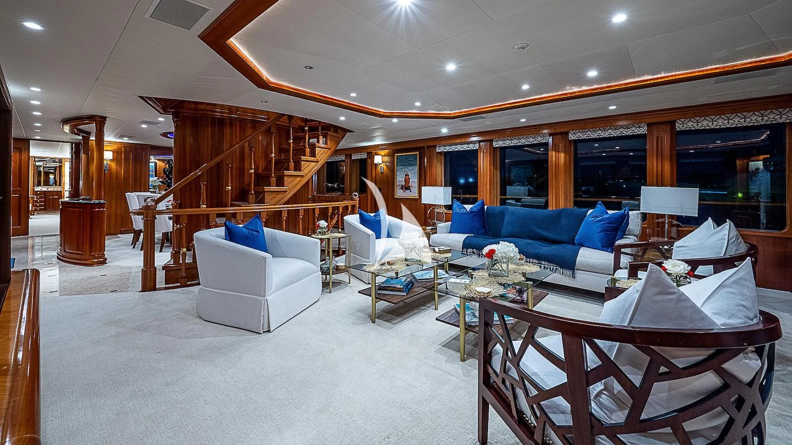 a large living room with a large open staircase aboard PACKAGE DEAL Yacht for Charter
