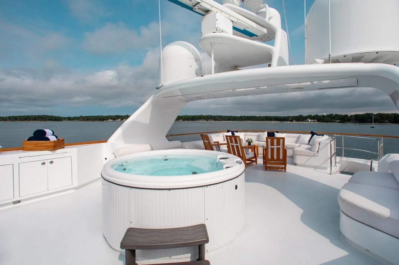 a large white boat on a white surface with chairs around it aboard PACKAGE DEAL Yacht for Charter