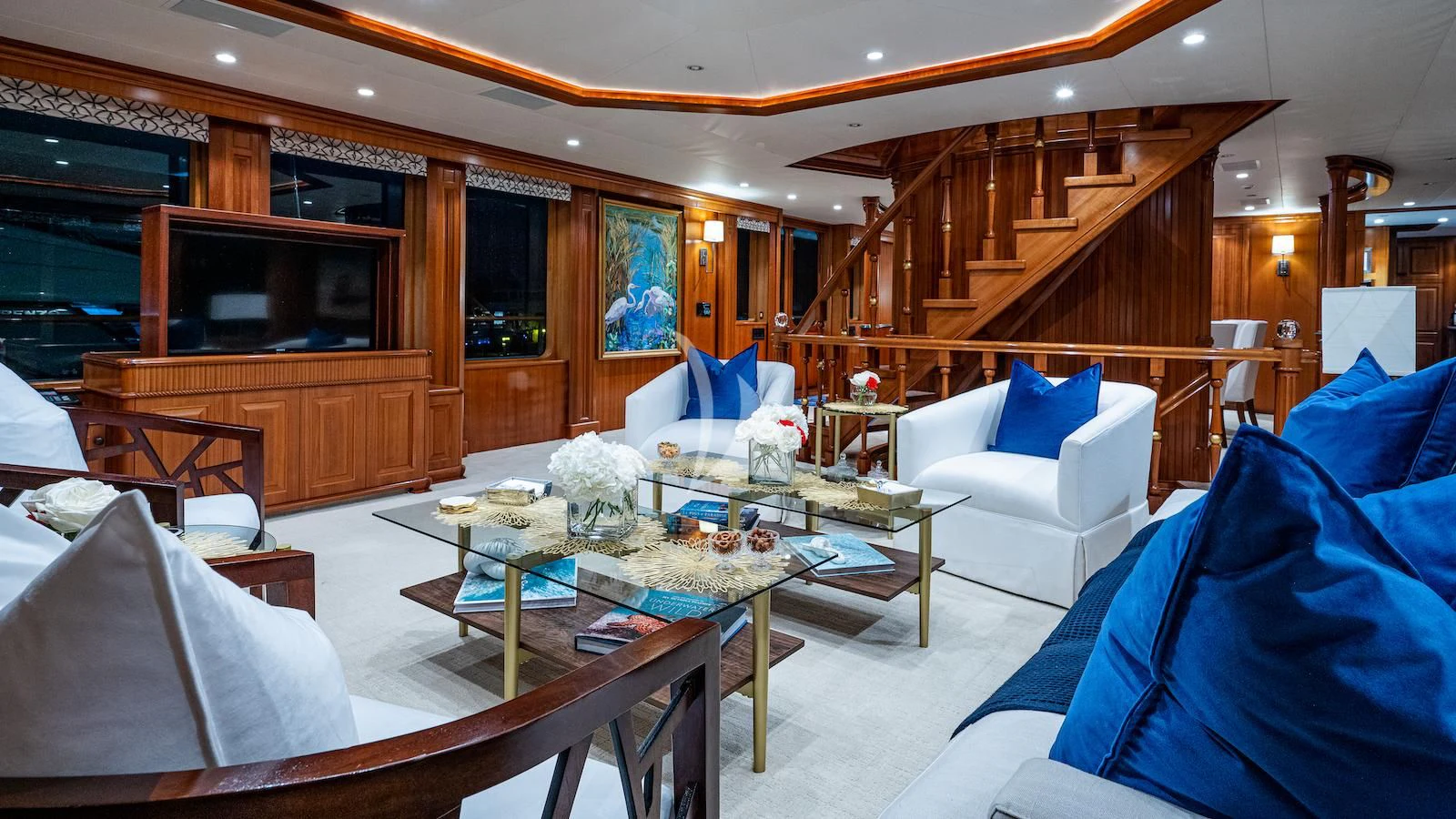 a room with a table chairs and a television aboard PACKAGE DEAL Yacht for Charter