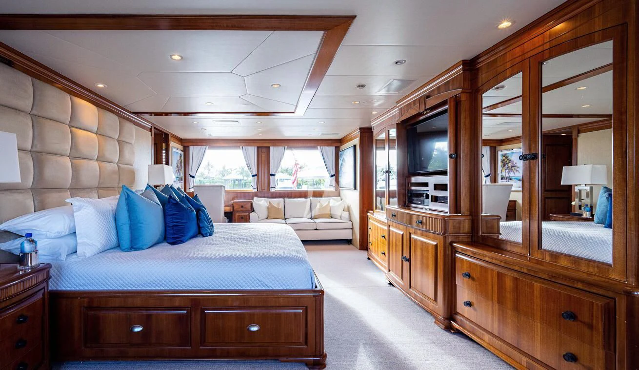 a bedroom with a bed and a mirror aboard PACKAGE DEAL Yacht for Charter