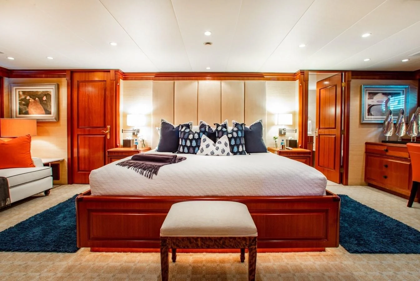 a bed with a white bed spread aboard PACKAGE DEAL Yacht for Charter
