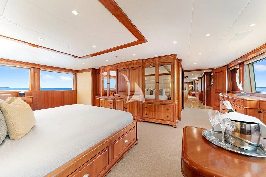 a bedroom with a bed and a table aboard PACKAGE DEAL Yacht for Charter
