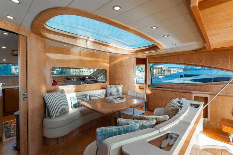 a room with a table and couches aboard WARLOCK Yacht for Sale