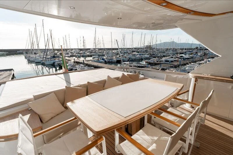 a table and chairs on a balcony aboard WARLOCK Yacht for Sale
