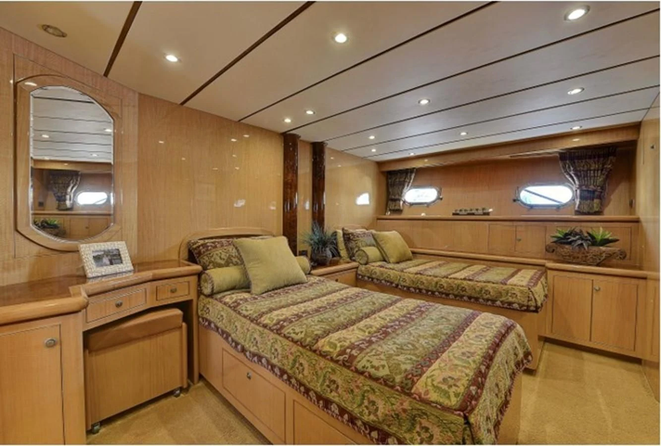 a bedroom with a bed and a desk aboard ANACAPA Yacht for Sale