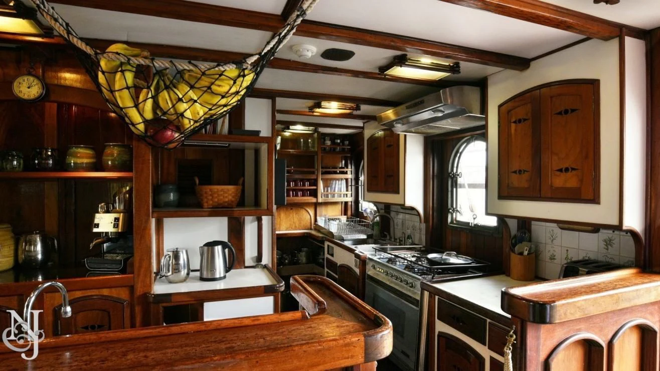 a kitchen with a stove and a coffee maker aboard PEACEMAKER Yacht for Sale