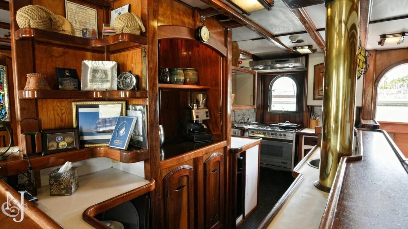 a kitchen with a wood cabinet aboard PEACEMAKER Yacht for Sale