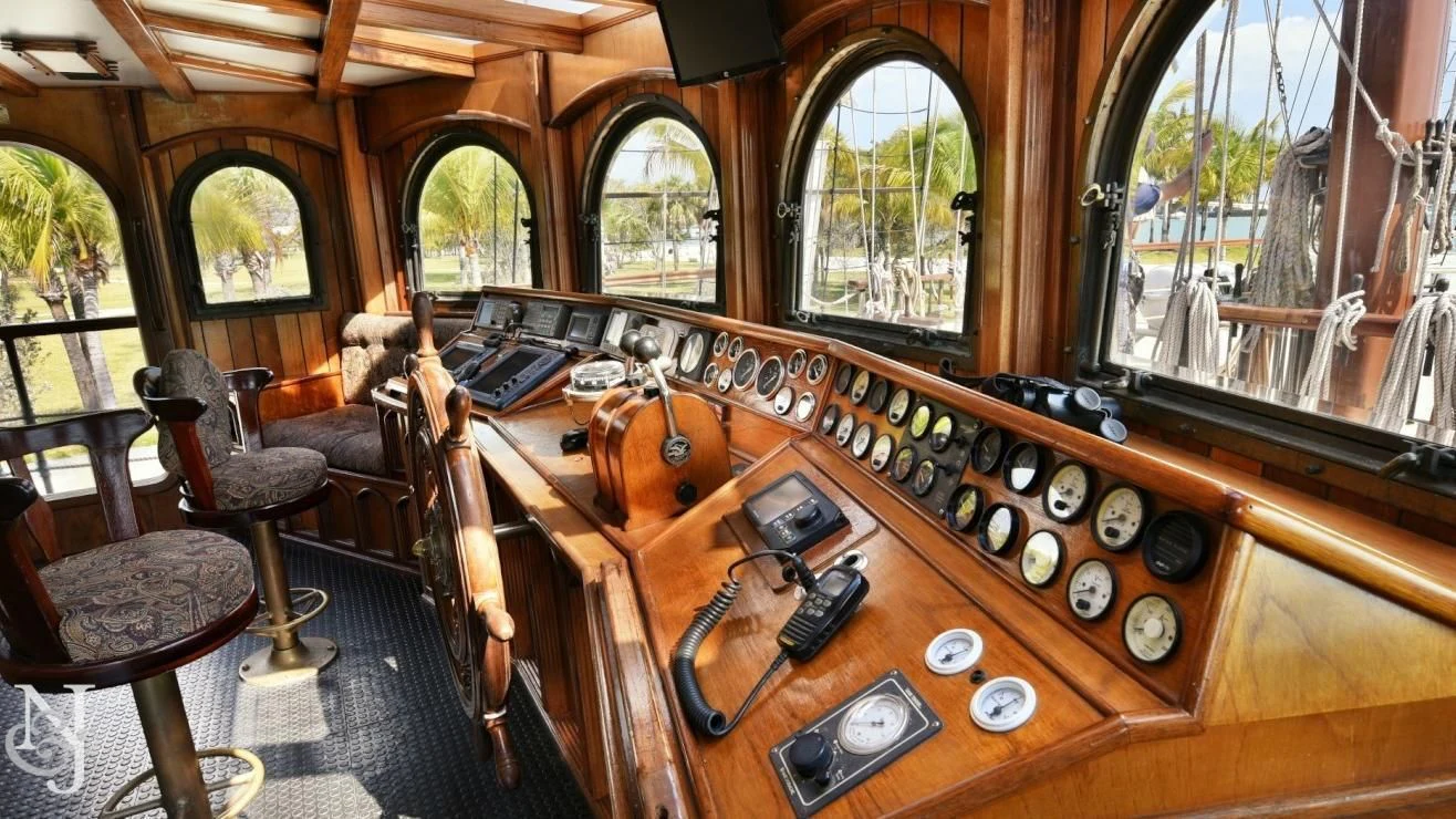 a wooden upright piano aboard PEACEMAKER Yacht for Sale