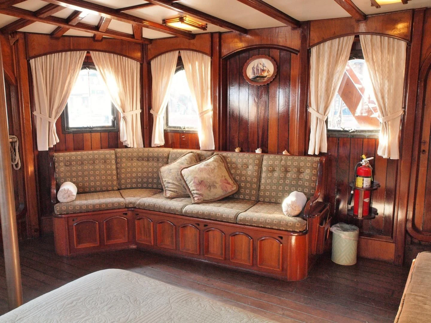 a living room with a couch and a window aboard PEACEMAKER Yacht for Sale