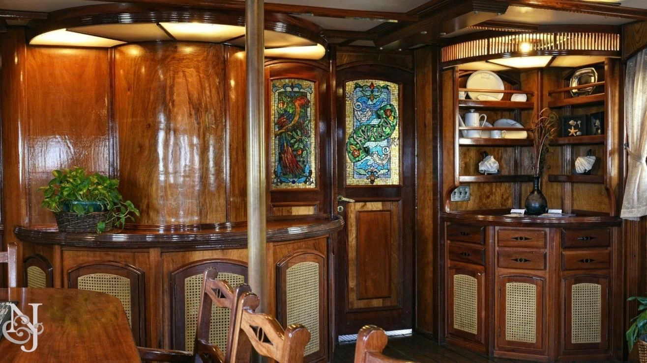 a room with a table and chairs aboard PEACEMAKER Yacht for Sale