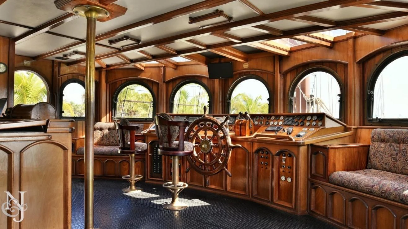 a large room with a piano and a chair aboard PEACEMAKER Yacht for Sale