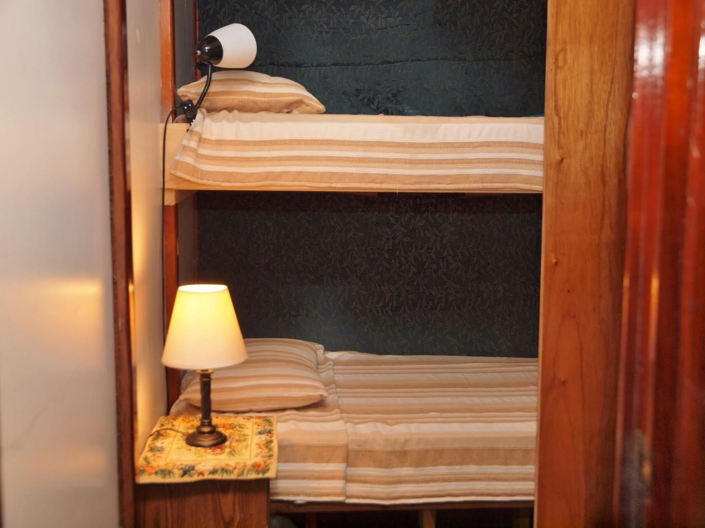 a bed with a lamp on it aboard PEACEMAKER Yacht for Sale