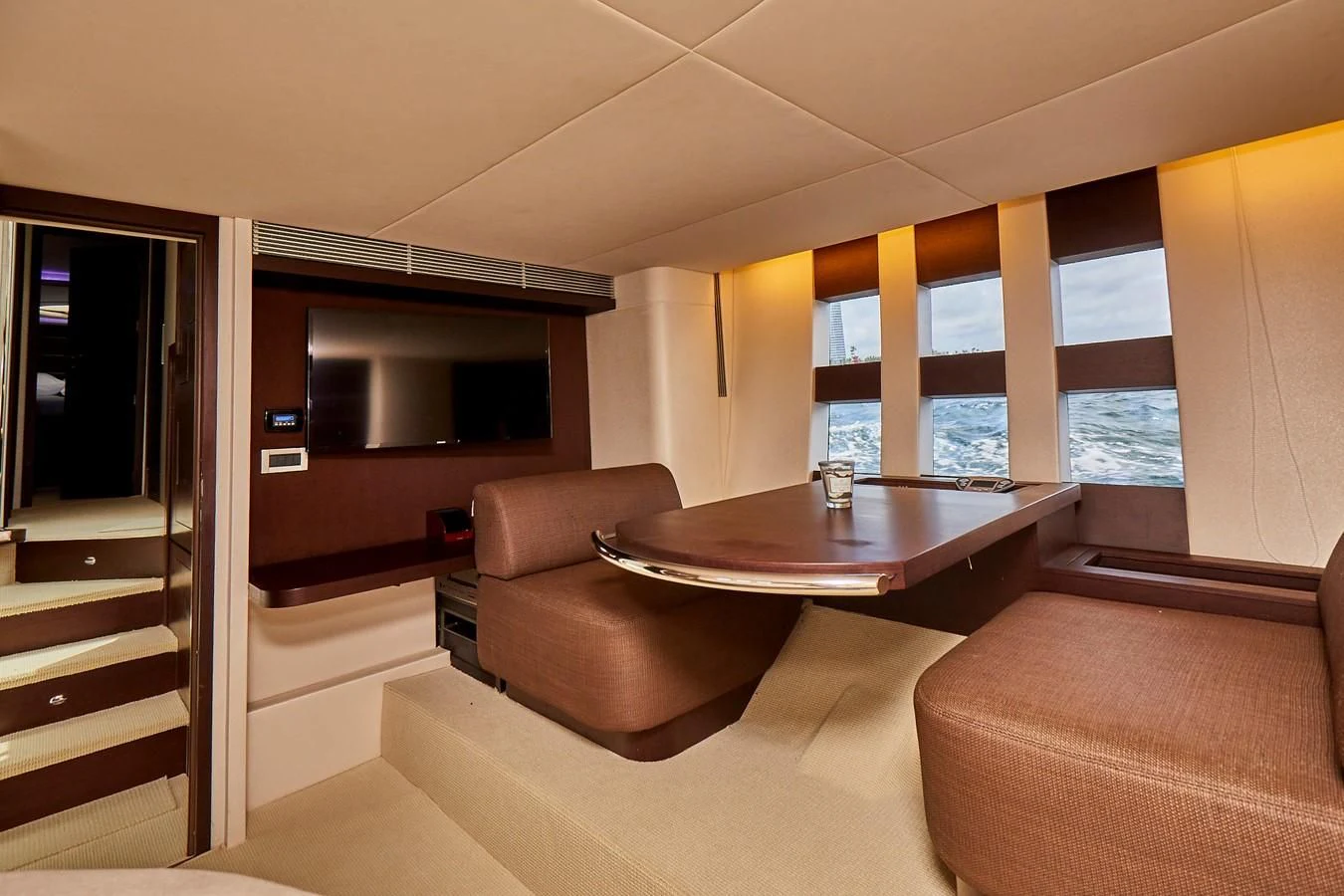 a living room with a table and couches aboard BLACK ICE Yacht for Sale