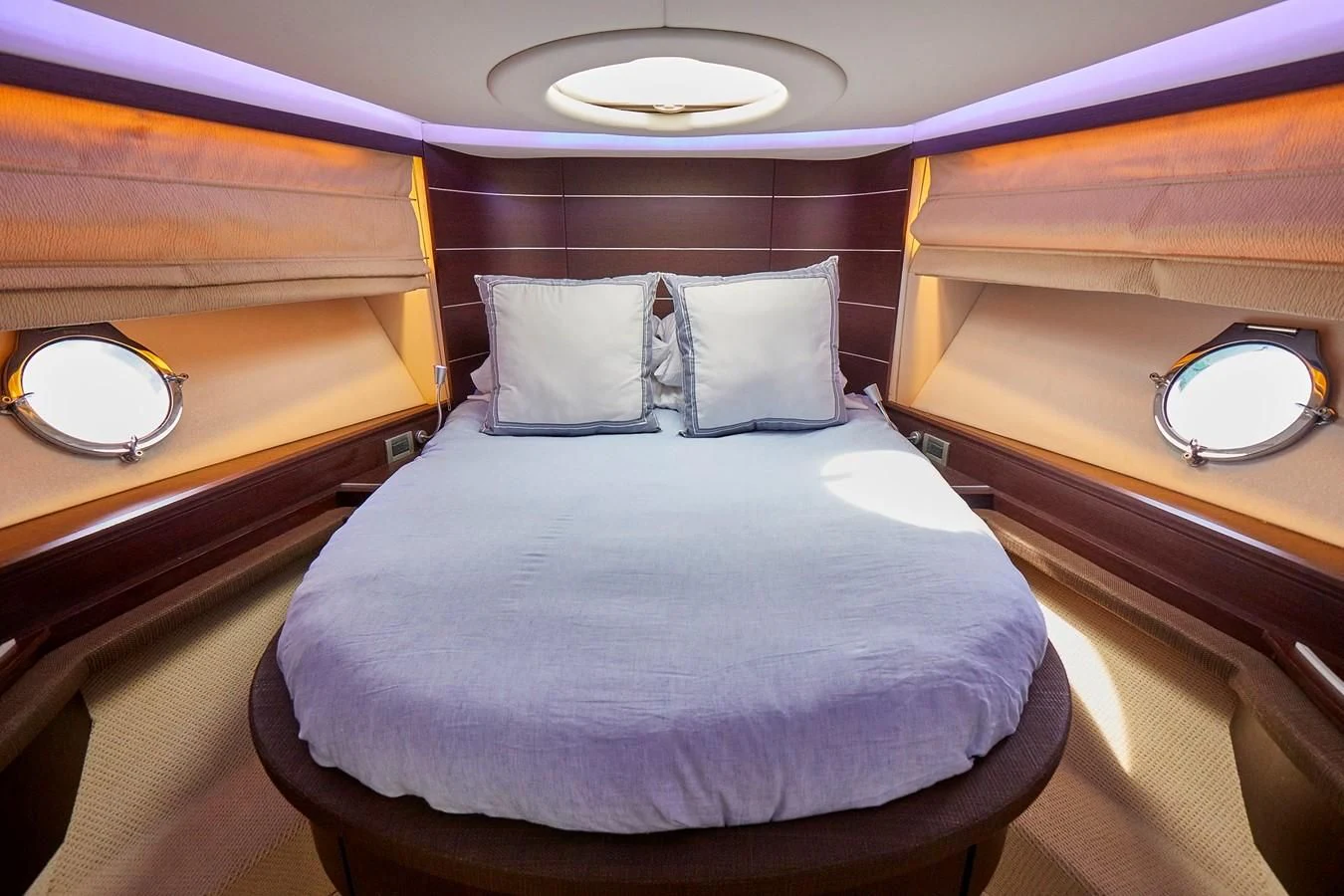 a bed with a mirror above it aboard BLACK ICE Yacht for Sale