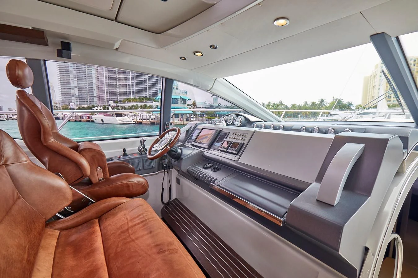 a person's hand on a steering wheel in a car aboard BLACK ICE Yacht for Sale