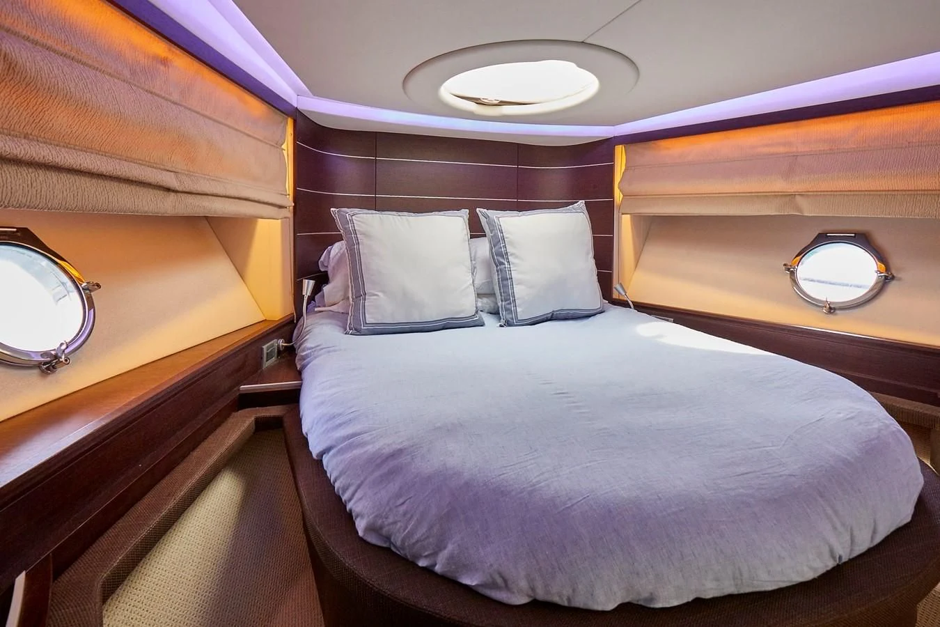 a bed with a white comforter aboard BLACK ICE Yacht for Sale