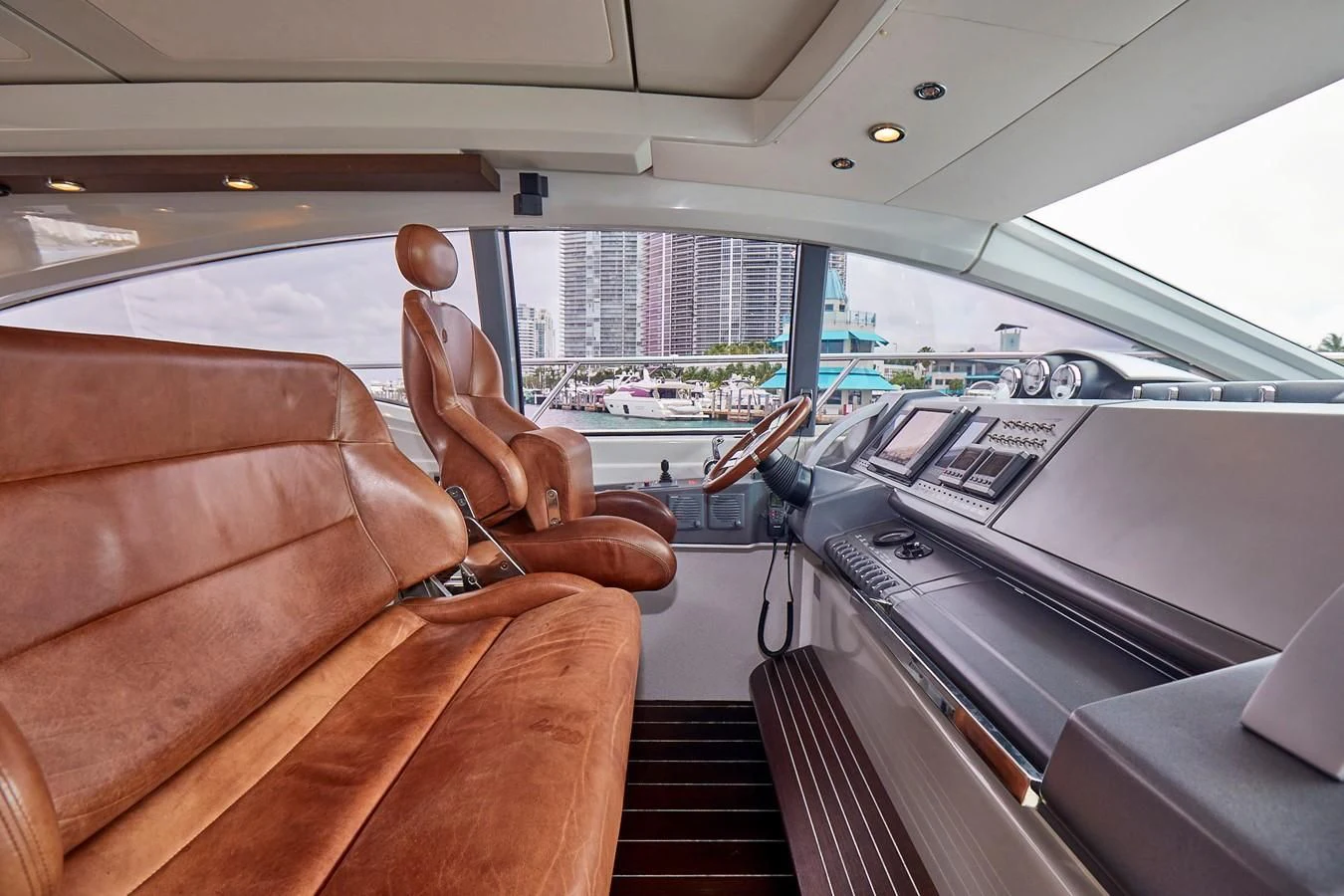 a pair of feet on a seat in a car aboard BLACK ICE Yacht for Sale