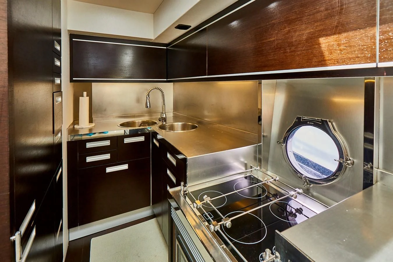 a modern kitchen with a large blue round mirror aboard BLACK ICE Yacht for Sale