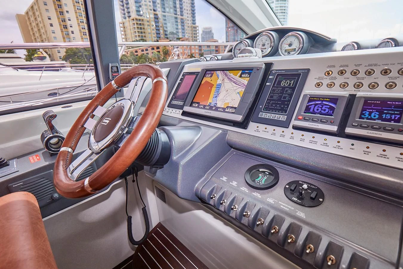 a hand holding a steering wheel aboard BLACK ICE Yacht for Sale