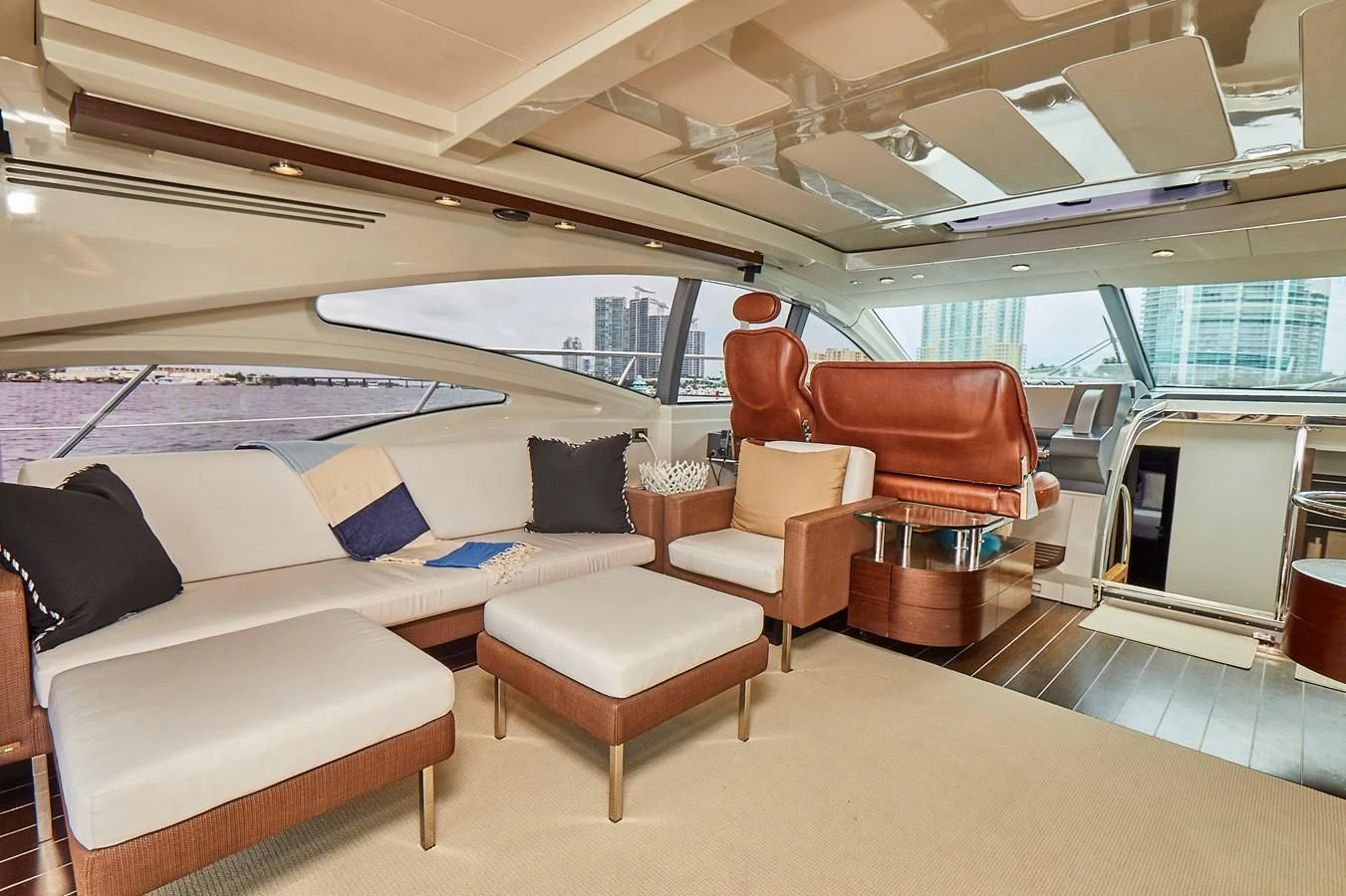 a boat with a couch and chairs aboard BLACK ICE Yacht for Sale