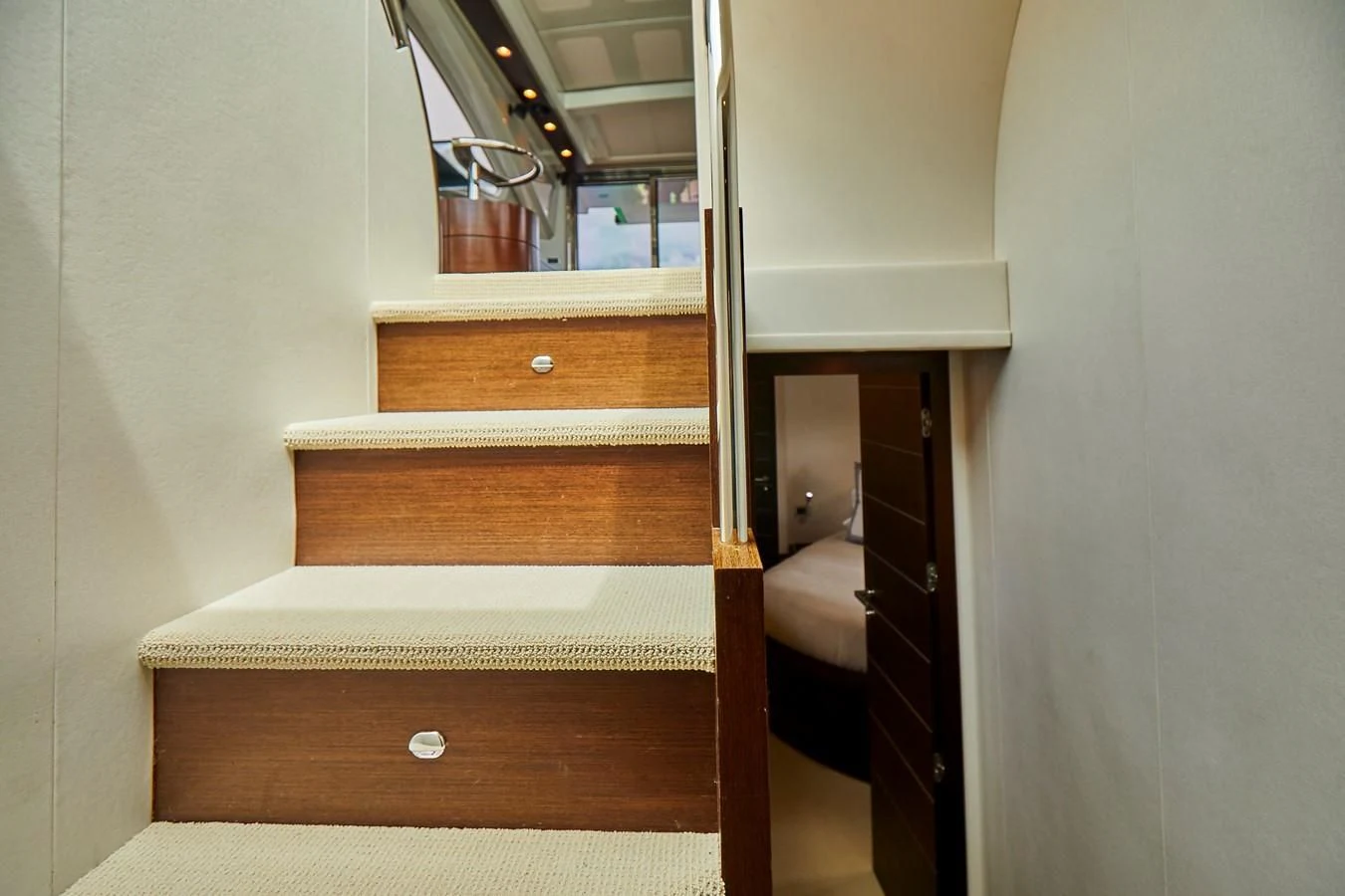 a wooden staircase with a wood railing aboard BLACK ICE Yacht for Sale