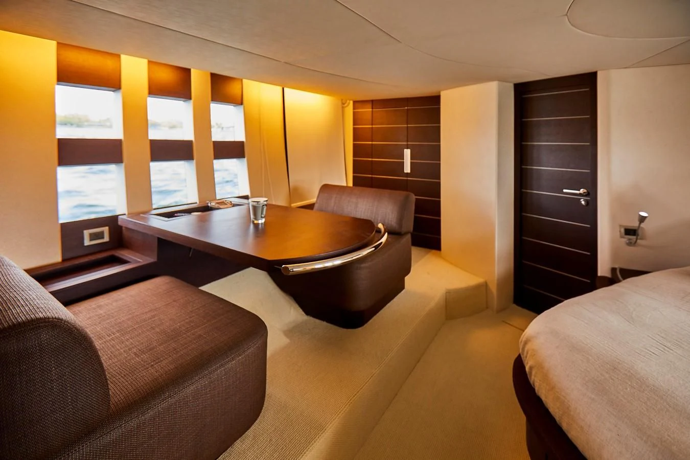 a living room with a table and couches aboard BLACK ICE Yacht for Sale