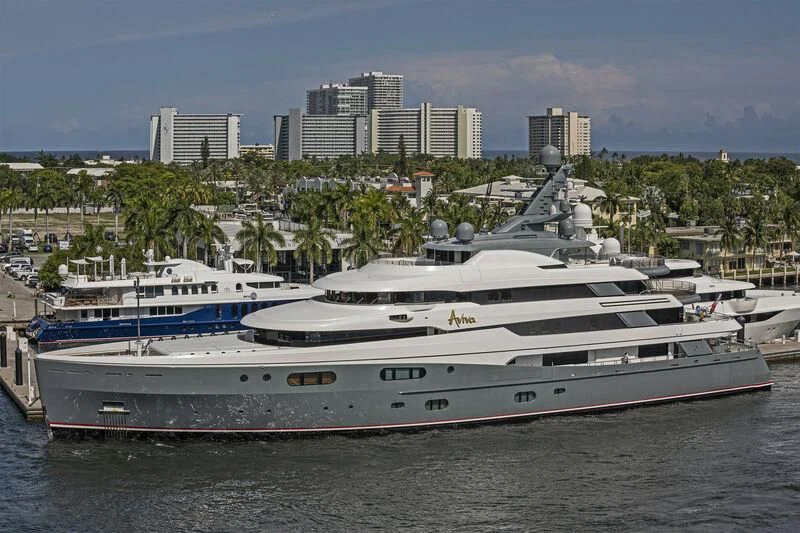 a large white boat in a harbor aboard AVIVA Yacht for Sale