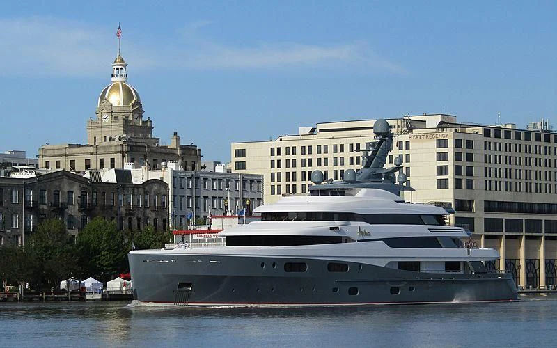 a large cruise ship in front of a large building aboard AVIVA Yacht for Sale