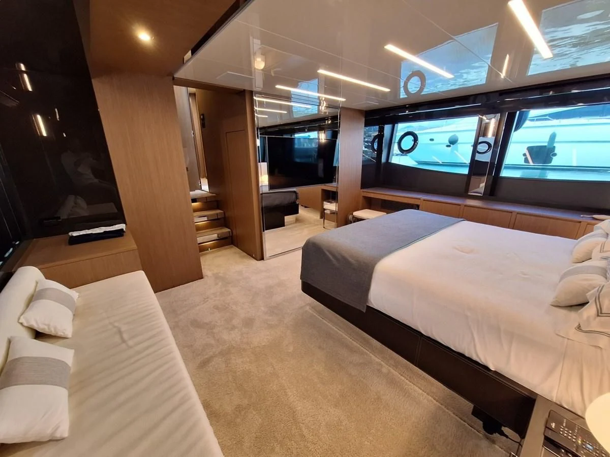 a room with a bed and a tv aboard CHILUCE Yacht for Charter