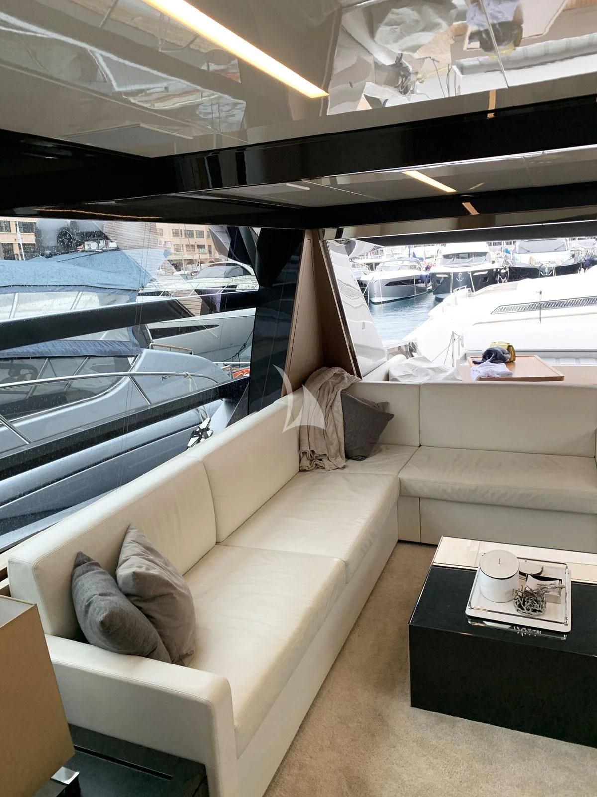 a living room with a large window aboard CHILUCE Yacht for Charter