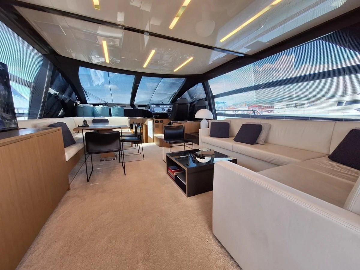 inside of a vehicle with a couch and a table and chairs aboard CHILUCE Yacht for Charter