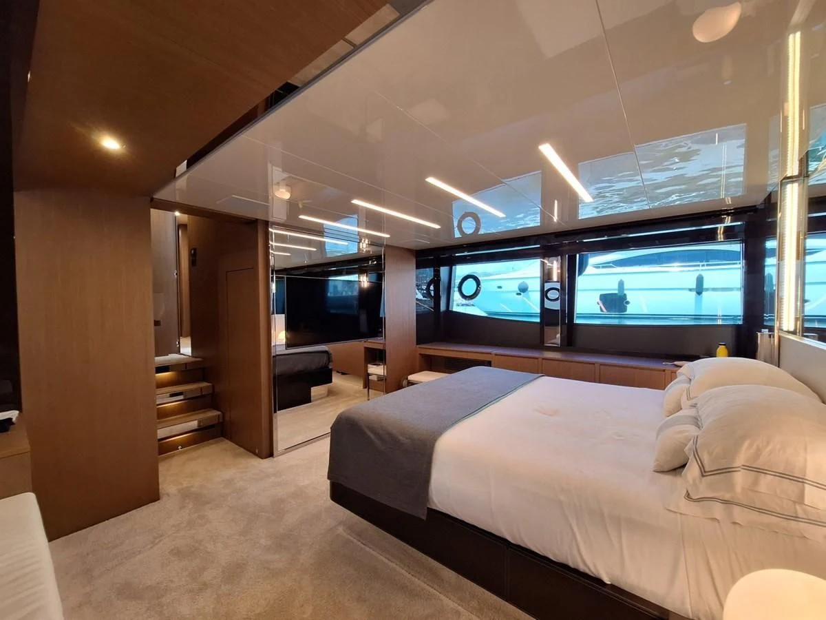 a bedroom with a large window aboard CHILUCE Yacht for Charter