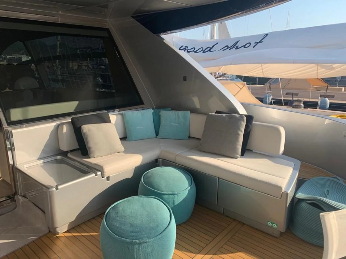 a couch and a chair in a room aboard CHILUCE Yacht for Charter