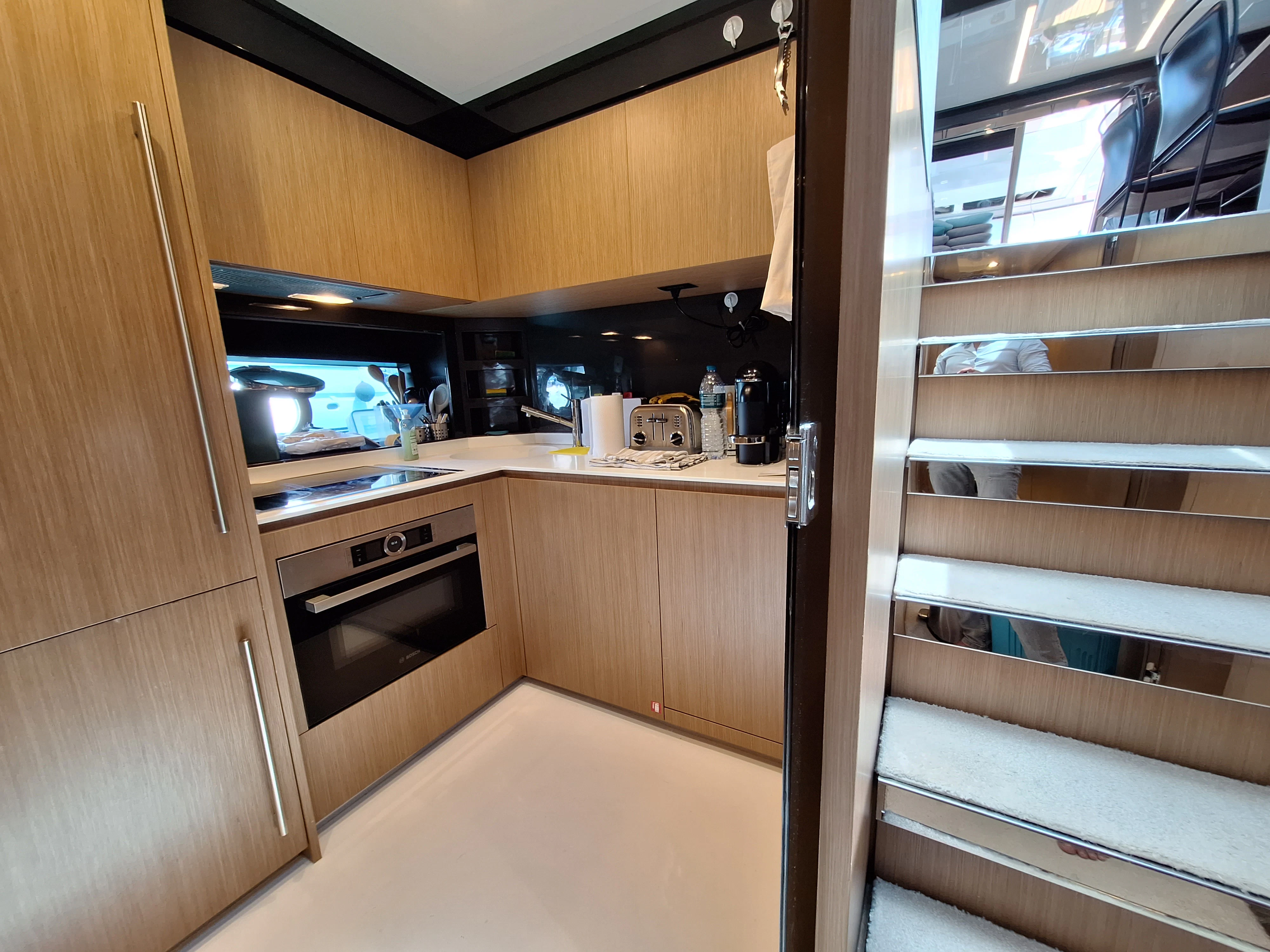 a kitchen with wooden cabinets aboard CHILUCE Yacht for Charter