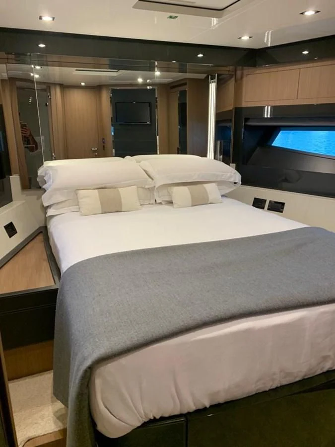 a bed with white sheets aboard CHILUCE Yacht for Charter