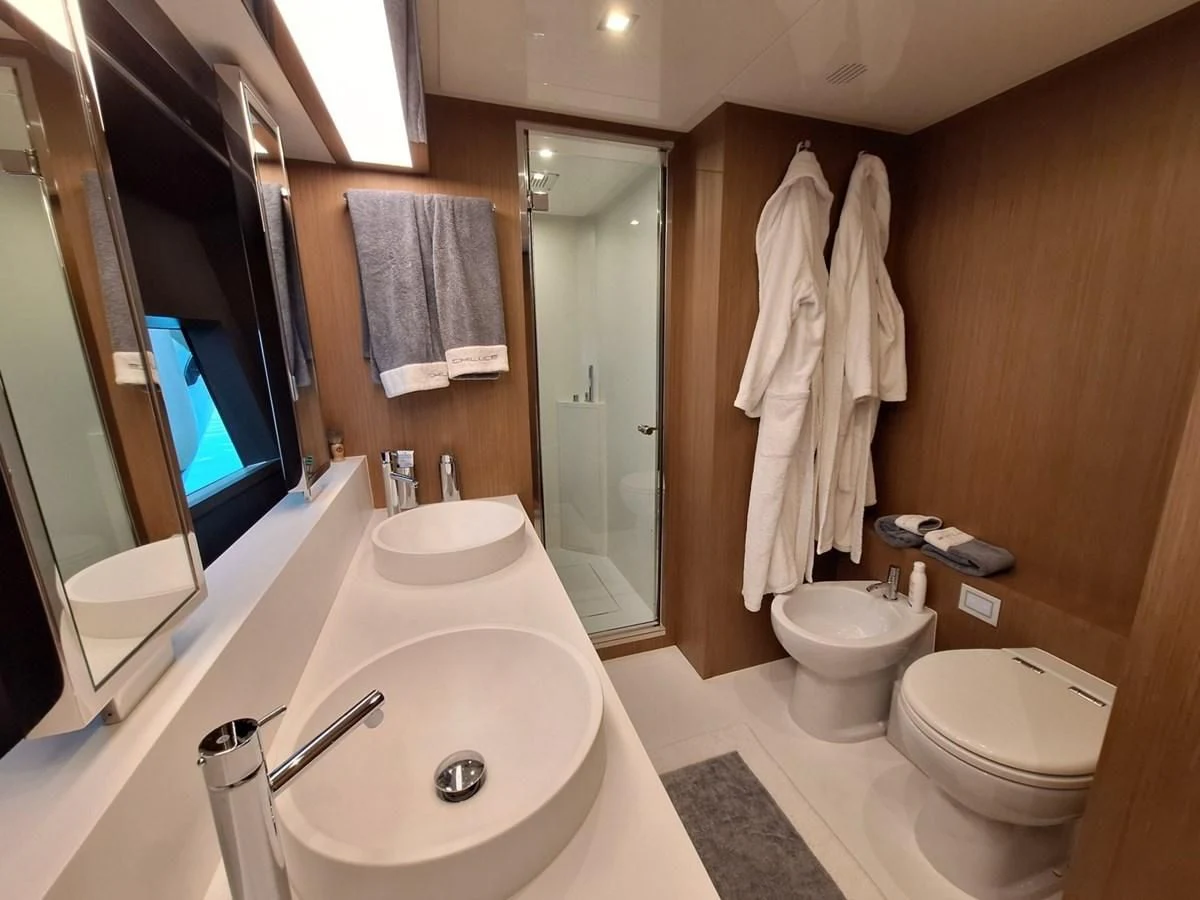 a bathroom with a bathtub toilet and sink aboard CHILUCE Yacht for Charter